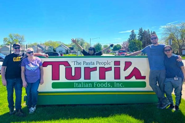happy-turris-employees-by-marquee-sign
